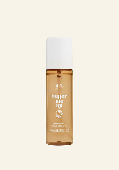 Perfume bottle labeled ' butter me up' on a beige background